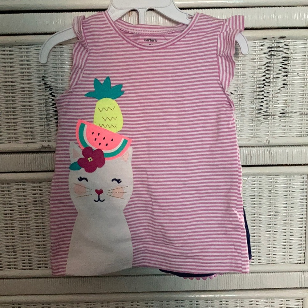 Purple & white top, blue shorts with purple fringe
